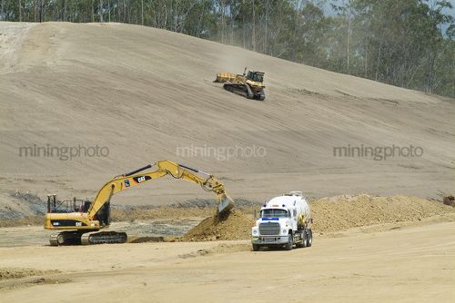 Heavy machinery working on the building of a highway - Mining Photo Stock Library