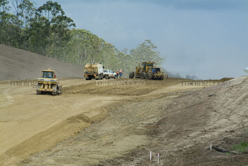Heavy machinery working on the building of a highway transport corridor - Mining Photo Stock Library