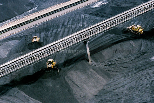 Aerial photo bulldozers stockpiling coal at port facility - Mining Photo Stock Library