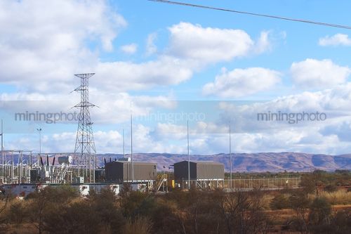 Power station at a remote mine site.  transmission tower standing tall. - Mining Photo Stock Library