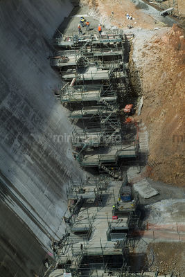 Major scaffolding on dam wall upgrade with concrete pouring at the top  - Mining Photo Stock Library