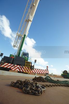 Chains for heavy lifting with crane in the background. - Mining Photo Stock Library