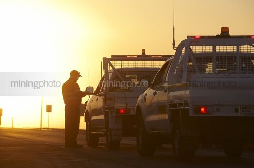 Sunrise on a mine site.  Security checking passes at the gate. - Mining Photo Stock Library