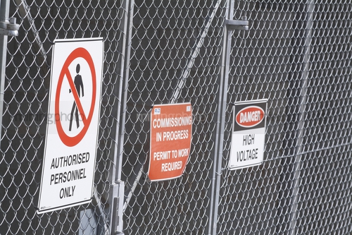 Safety signs on fence - Mining Photo Stock Library