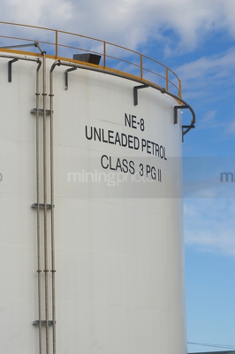Petrol storage towers with blue sky behind. - Mining Photo Stock Library