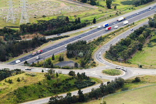 Aerial of roundabout off ramp from major highway transport system - Mining Photo Stock Library