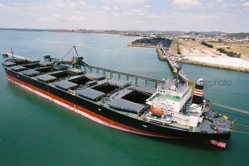 Ship being loaded with coal at terminal - Mining Photo Stock Library