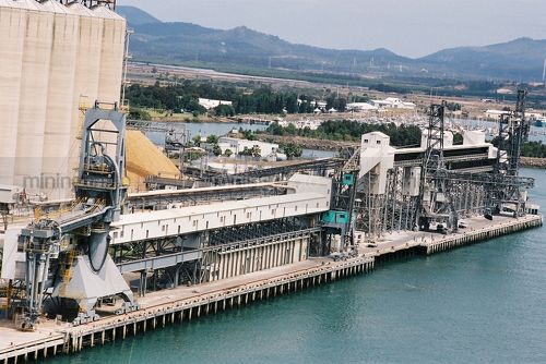 Wharf  with silos and ship loaders - Mining Photo Stock Library