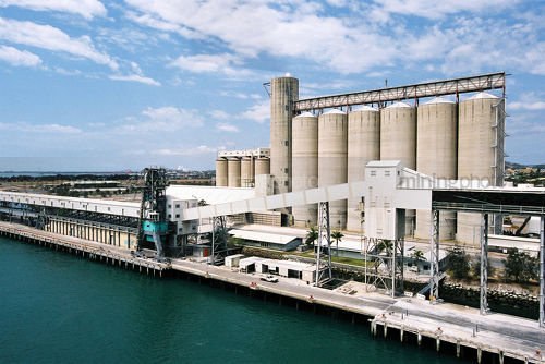 Tall storage silos on ship wharf.  aerial image. - Mining Photo Stock Library