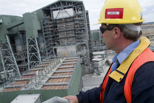 Supervisor in ppe overseeing powerstation - Mining Photo Stock Library