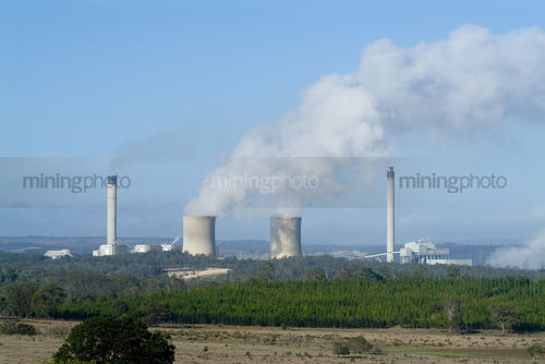 Distance shot of water cooling towers from a coal fired power station - Mining Photo Stock Library