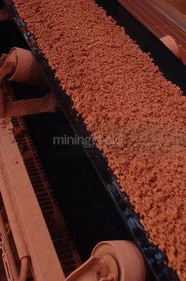 Moving conveyor of bauxite closeup - Mining Photo Stock Library