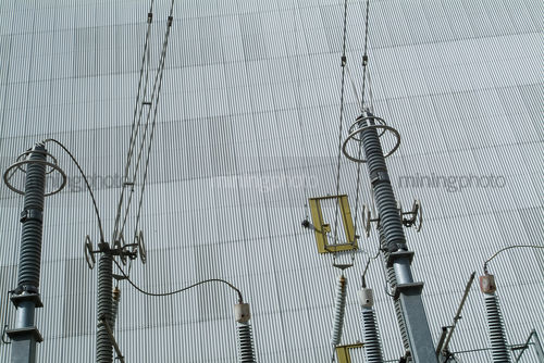 External walls of power station with transformer tower in foreground - Mining Photo Stock Library