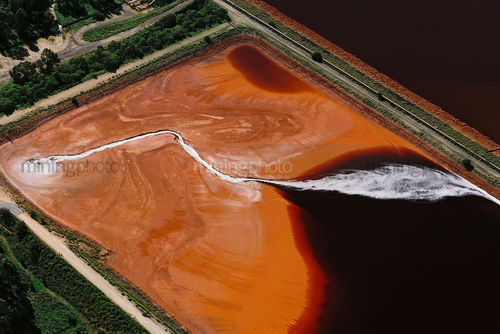 Bright contrast tailings dam shot from the air.  unusual patterns - Mining Photo Stock Library