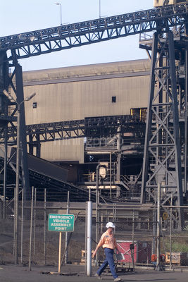 Worker leaving min site with wash processing plant in background - Mining Photo Stock Library
