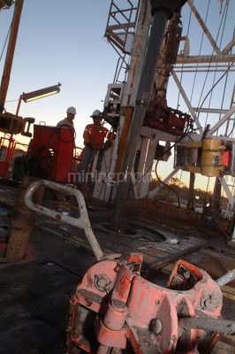 Workers on a drill rig early morning - Mining Photo Stock Library