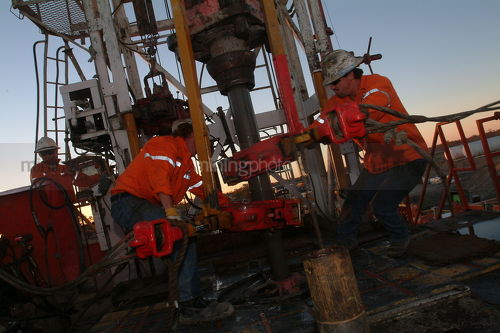 Workers on drill rig  early morning - Mining Photo Stock Library