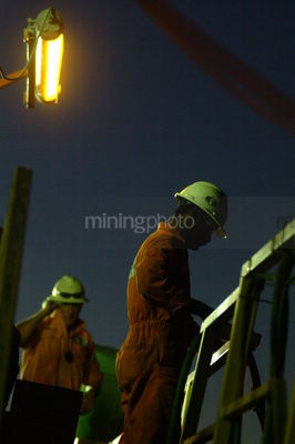 2 drill rig workers on walkway in full PPE  - Mining Photo Stock Library