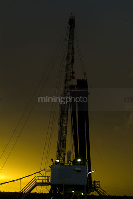 Drill rig during dusk storm - Mining Photo Stock Library