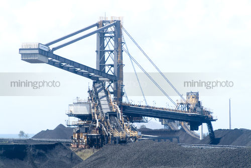 Coal loader stockpiling at  port terminal  - Mining Photo Stock Library