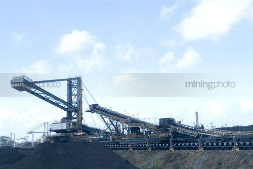 Ship loaders loading coal at terminal - Mining Photo Stock Library