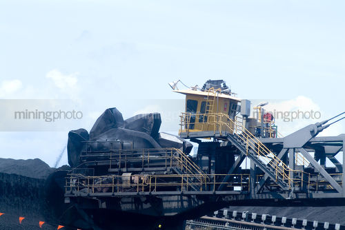 Reclaimer loading coal at terminal  closeup and operating - Mining Photo Stock Library