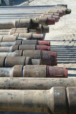 Pipe casing closeup ready to install on oil and gas rig - Mining Photo Stock Library