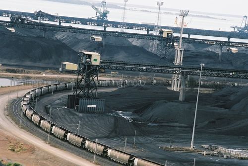 Heavy rail carts emptying coal at wharf terminal - Mining Photo Stock Library