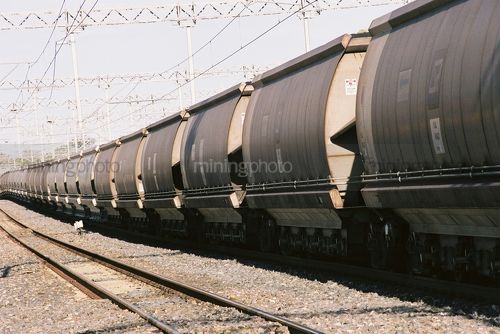 Many coal train heavy rail carriages  - Mining Photo Stock Library