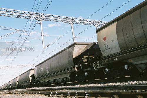 Closeup of tipping coal carriages shot from ground level - Mining Photo Stock Library