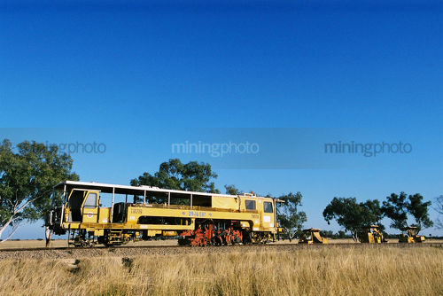 Heavy rail track repair train in Western Australia in rural countryside - Mining Photo Stock Library