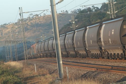 Coal train carriages on track in mine site environment - Mining Photo Stock Library