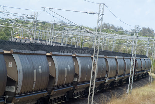 Long coal train winding its way through rural countryside. - Mining Photo Stock Library