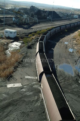 Aerial image of coal train carriages waiting to be loaded at coal mine site. - Mining Photo Stock Library