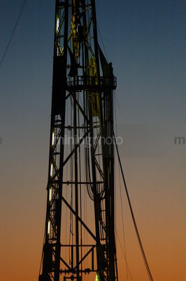 Drill rig derrick closeup shot at sunset. - Mining Photo Stock Library
