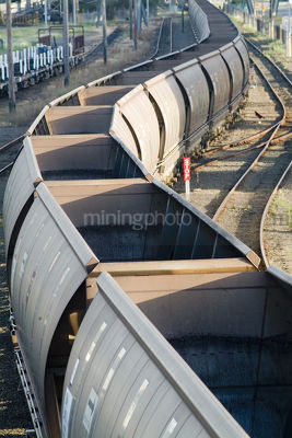 Empty coal train carriages waiting to be filled at mine site - Mining Photo Stock Library