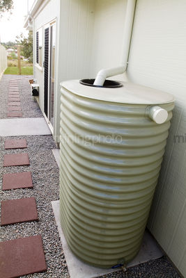 Domestic rain water tank installed at residential house.  - Mining Photo Stock Library
