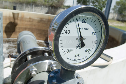 Water gauge on a pipe at a water treatment works. - Mining Photo Stock Library
