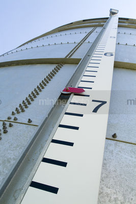 Looking up the outside of a water  holding tank.  numbers on the outside to say how deep. - Mining Photo Stock Library