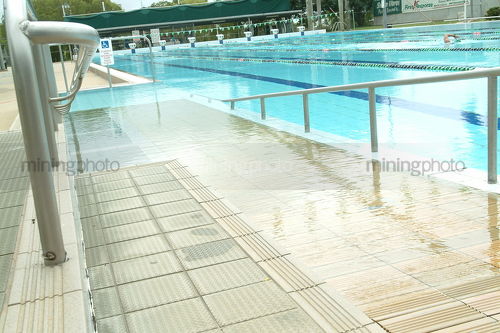 Handicapped disabled access ramp into public swimming pool - Mining Photo Stock Library
