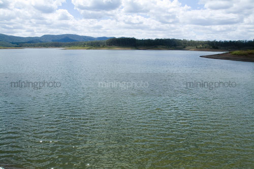 Aerial of large dam that is city water supply - Mining Photo Stock Library