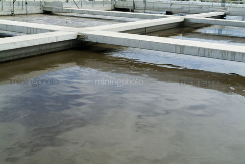 Walkways above water separation ponds at water  treatment works - Mining Photo Stock Library