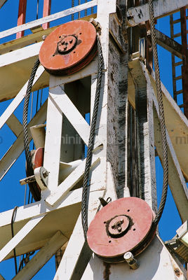 The large pulley systems on a drill rig derrick. - Mining Photo Stock Library