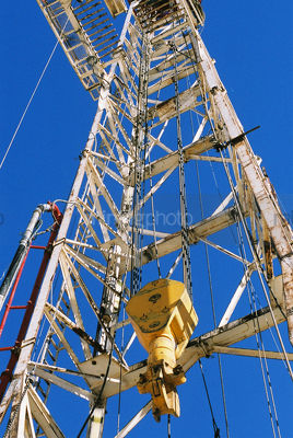 Hook and cables hanging on drill rig derrick - Mining Photo Stock Library