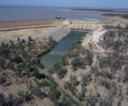 Aerial of major outback dam.  depicts dam wall, overflow surrounding vegetation and water in stock. - Mining Photo Stock Library