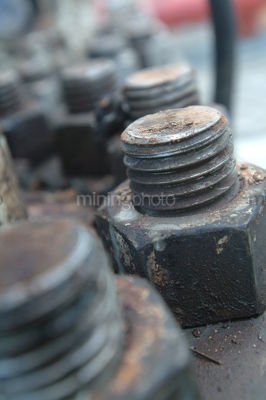Closeup of nuts and bolts on drill rig. - Mining Photo Stock Library