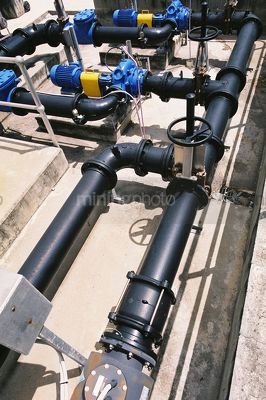 Water pipes and valves at treatment plant. - Mining Photo Stock Library