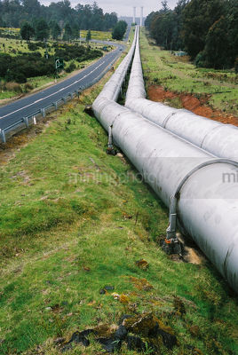 City hydro water pipes next to road - Mining Photo Stock Library