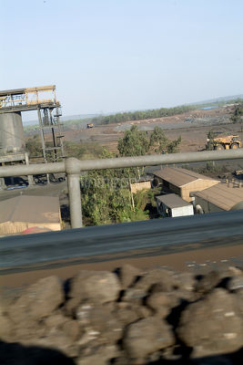 Moving conveyor with ore product.  mine and country in background. - Mining Photo Stock Library