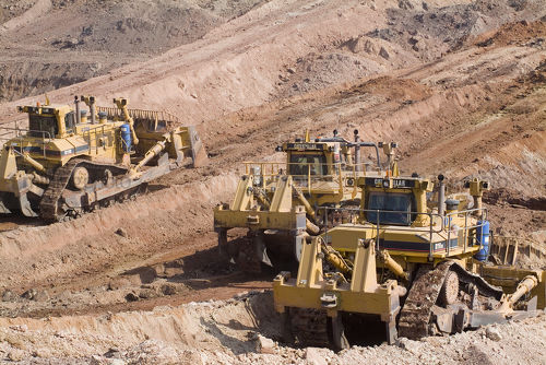 Three bulldozers pushing overburden to expose product. - Mining Photo Stock Library
